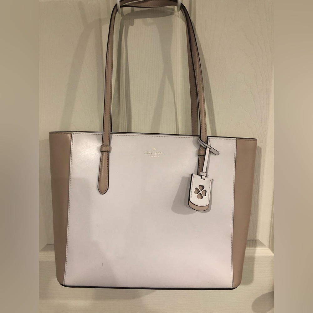 Kate spade tote. Used one summer.  2 small places as noted in pictures 14x11
